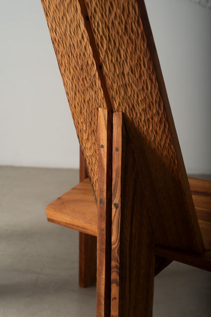 Rear detail of the Guama Lounge Chair, where the carved backrest meets the pale pegged uprights