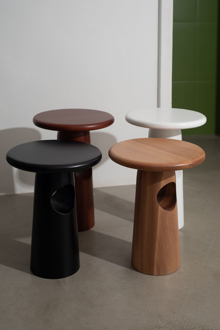 Close grouping of Singular Side Tables in black, dark red, natural wood and white