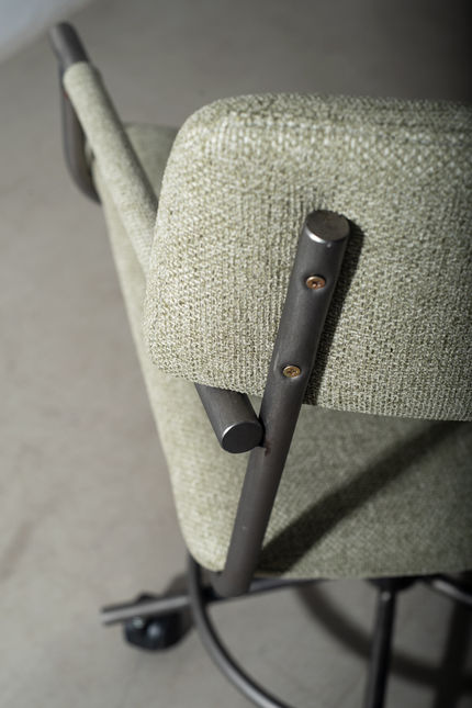 Detail of the sage textured upholstery and screwed steel backrest bracket of the Luiza Office Chair