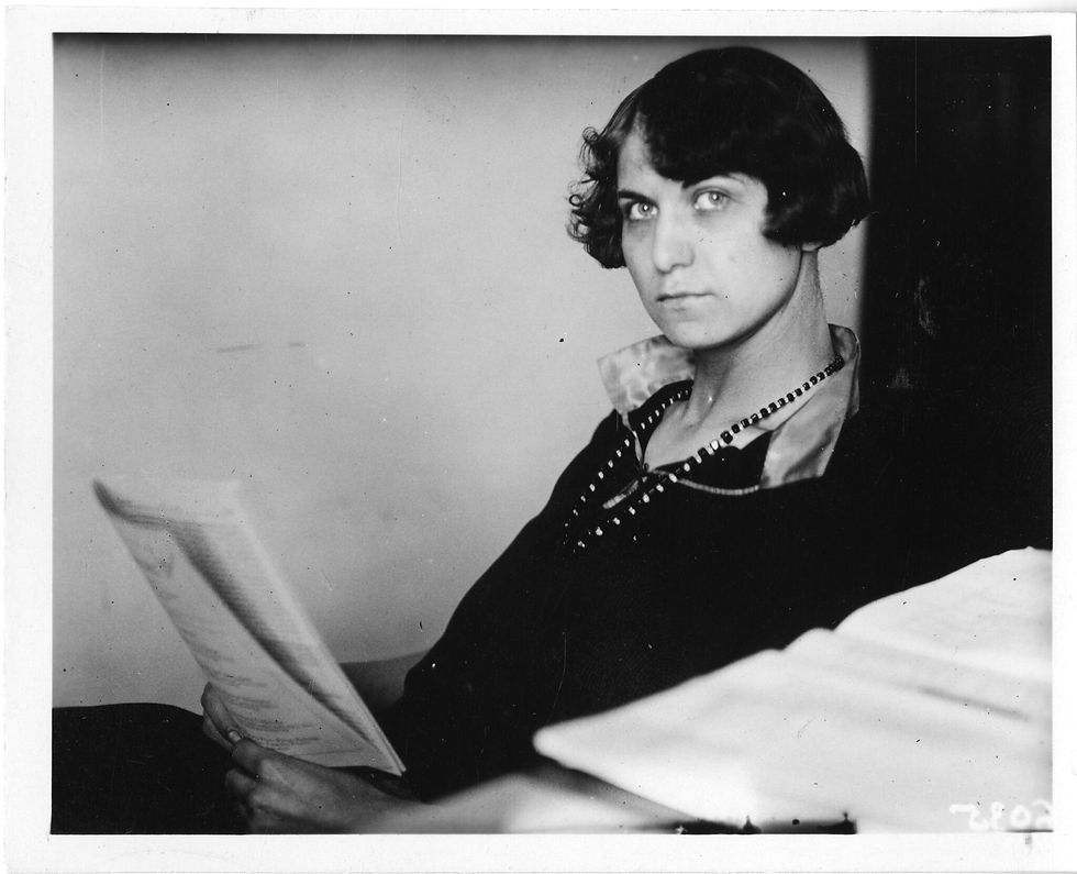 Woman looking intense - writing and reading an essay