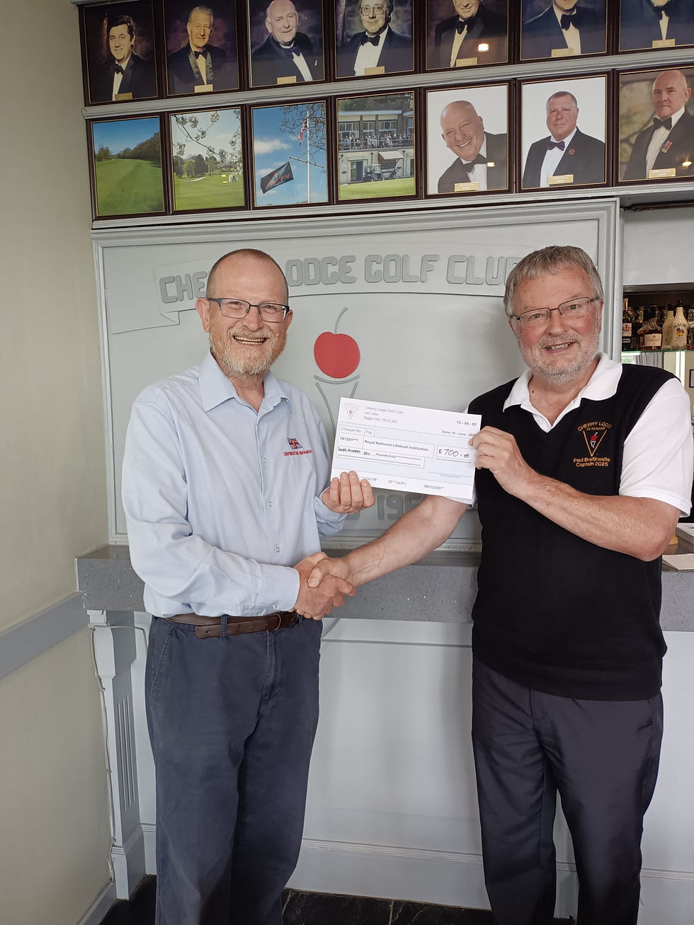 Captain Paul Braithwaite presenting a cheque for £700 to local RNLI Fundraising Chairman Mike Ruffhead