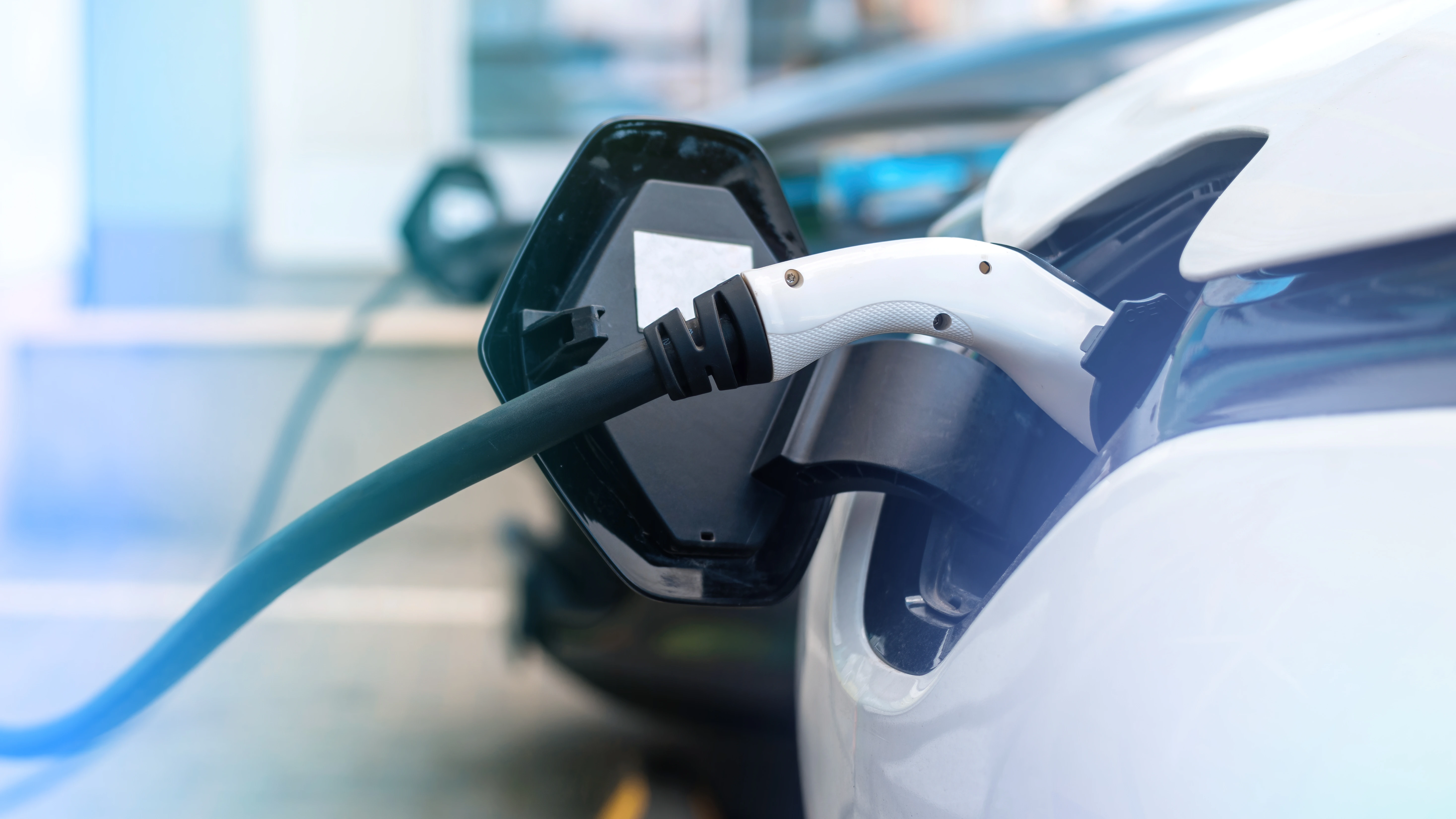 plugged-chargers-into-two-electric-cars-charge-station.webp
