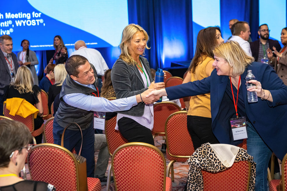 People shaking hands at a conference in Tucson 