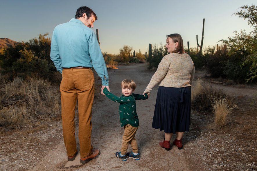 Oro Valley Family photos in the Desert. family of 3 with a kid in the center of the parents.