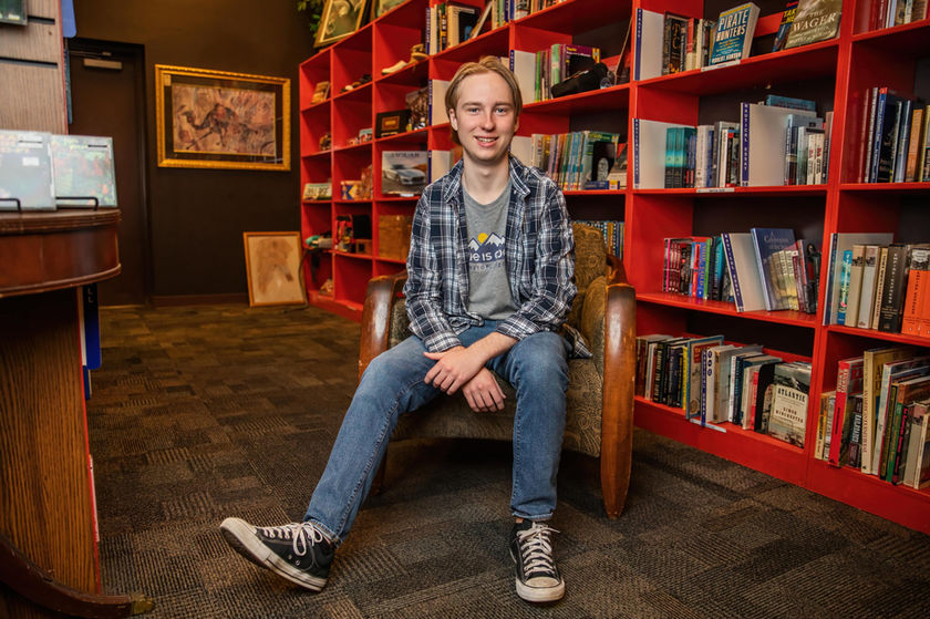 Tucson Senior's portrait at Bookman's (6230 E Speedway Blvd, Tucson, AZ 85712). The senior is sitting in a chair for his senior photo in tucson