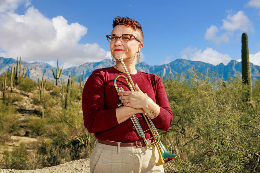 Photo from Oro Valley Photographers, of a woman posing with her trumpet.