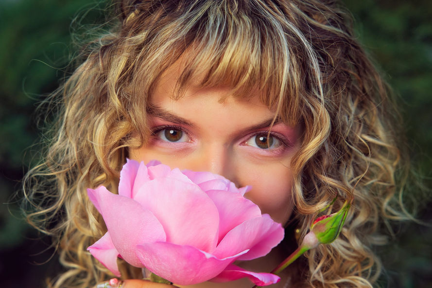 Photo of a woman hiding behind a pink rose in Oro Valley Arizona. Taken by Oro Valley Photographer. 