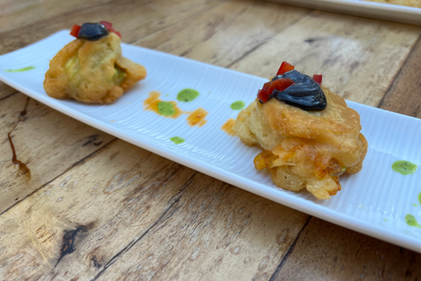 Coated Zuchini flower stuffed with shrimp covered in homemade black mayonaise.HEIC