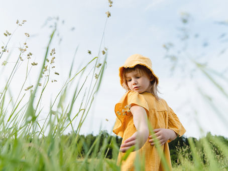 Child checking her arm for ticks after playing outdoors in Missouri.