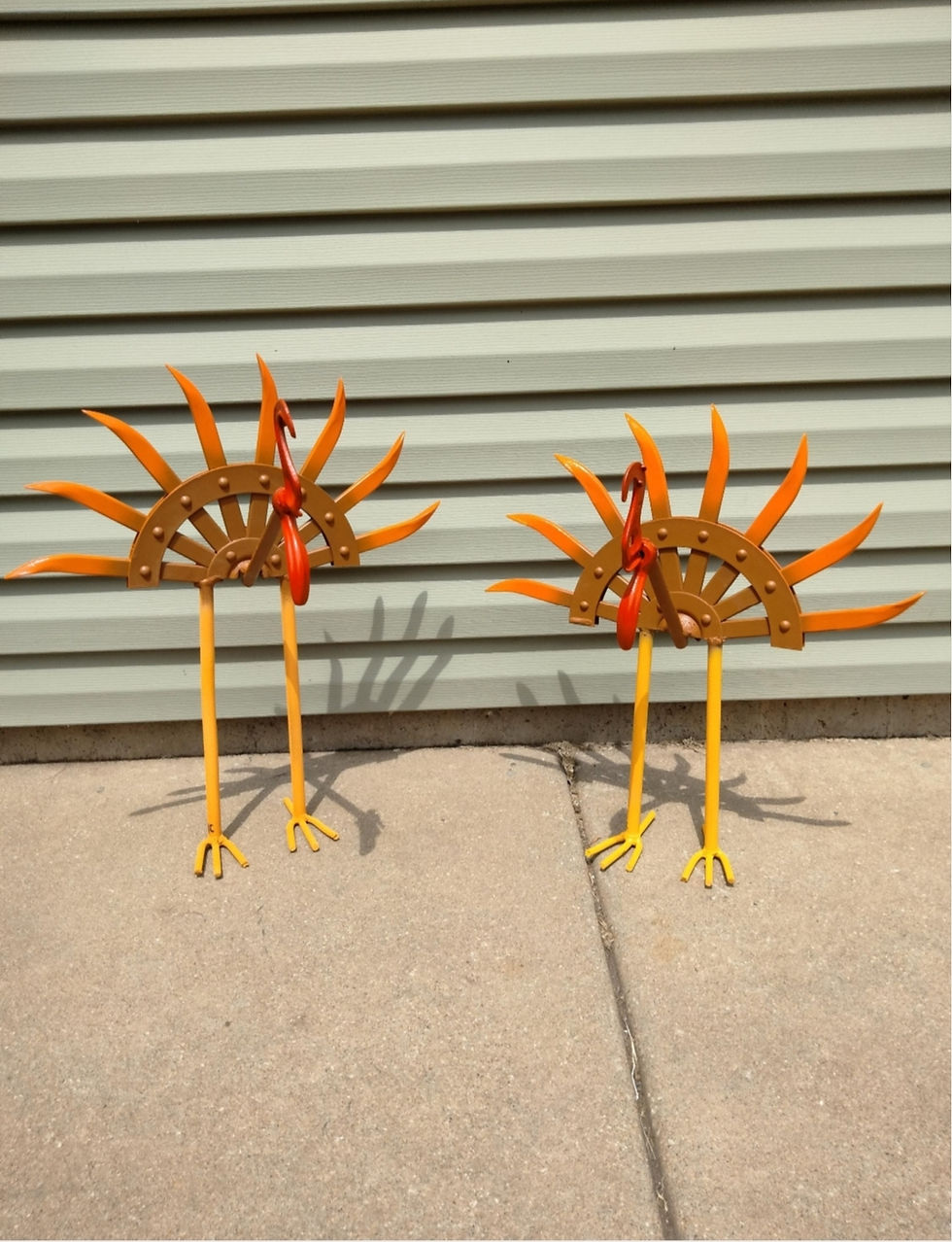 Two metal turkey sculptures, orange and brown