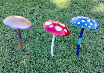 Three painted mushroom garden statues