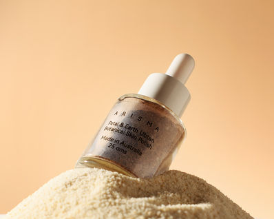 Skincare product bottle with visible text on sand, PRODUCT PHOTOGRAPHY, beige background, product photography by Karolina Ferbei Photography