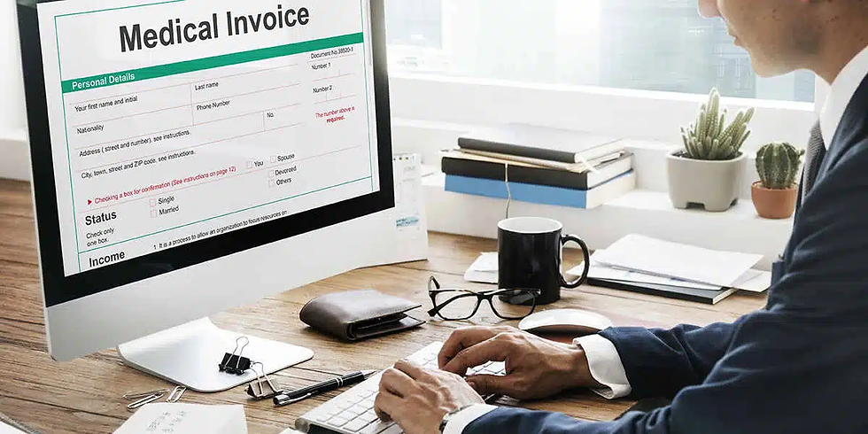 Man in suit working on computer displaying a medical invoice. Desk has a coffee cup, glasses, and notepad. Bright office with plants.
