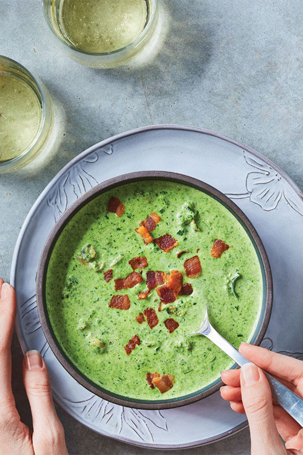 Green soup with bacon sprinkled on top