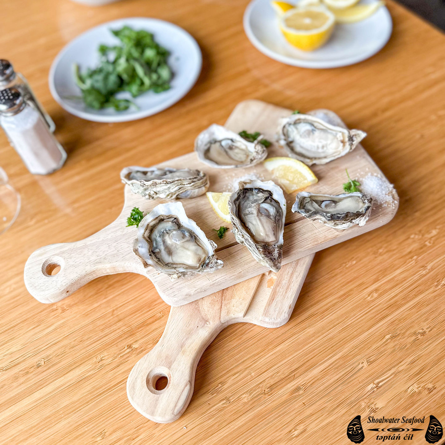 Shoalwater Seafood Half Shell Oysters on a wooden platter on a table
