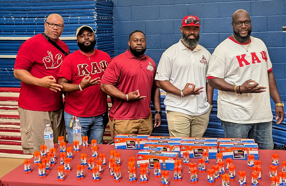 Denton-Lewisville (TX) Alumni Chapter members stand behind a table of school supplies at the 2025 NPHC Back to School Bash.