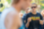 Runner in New Haven Road Race shirt holding a cup.