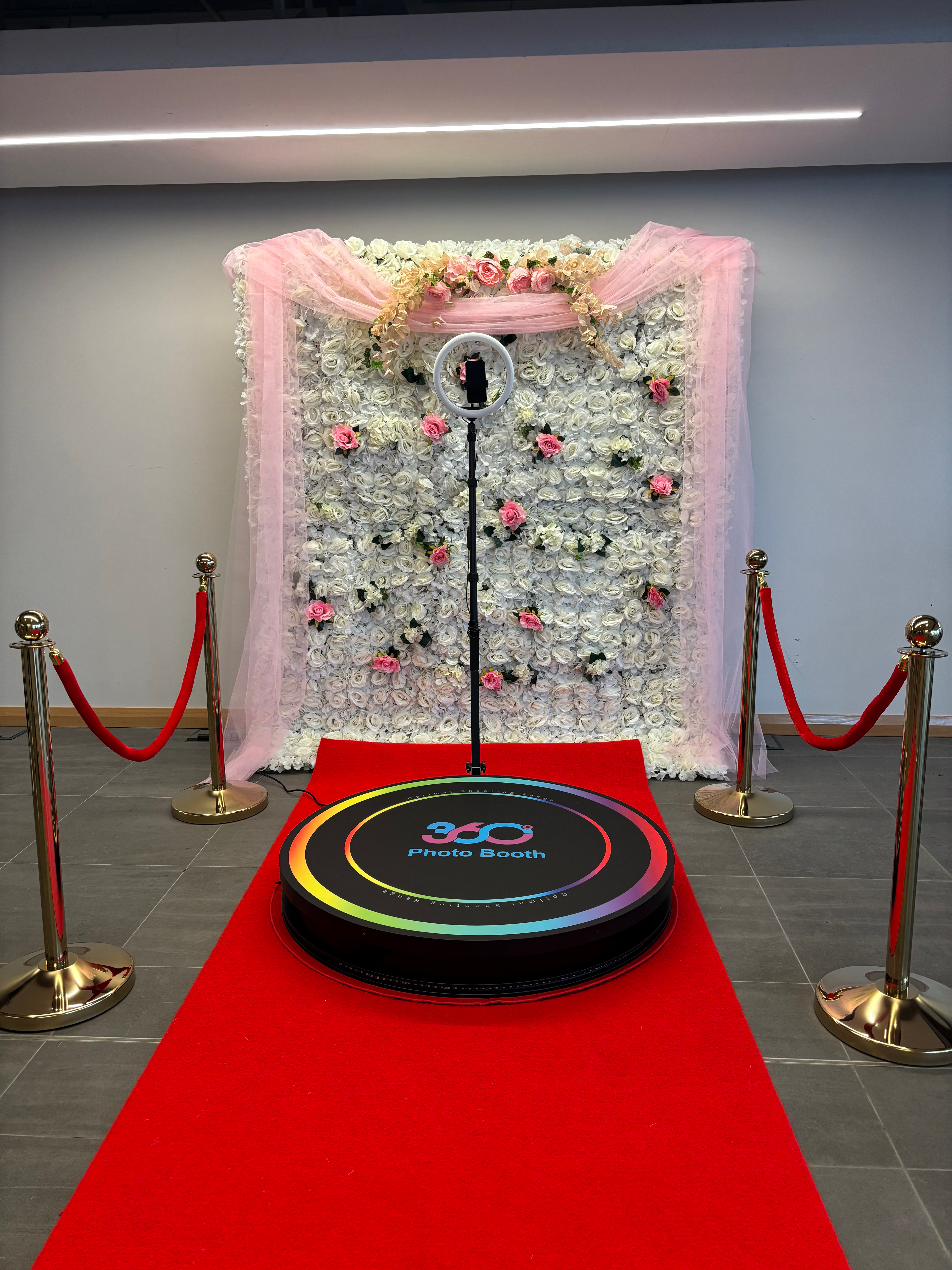 360 Booth on Red Carpet with Flower Wall and Gold Posts