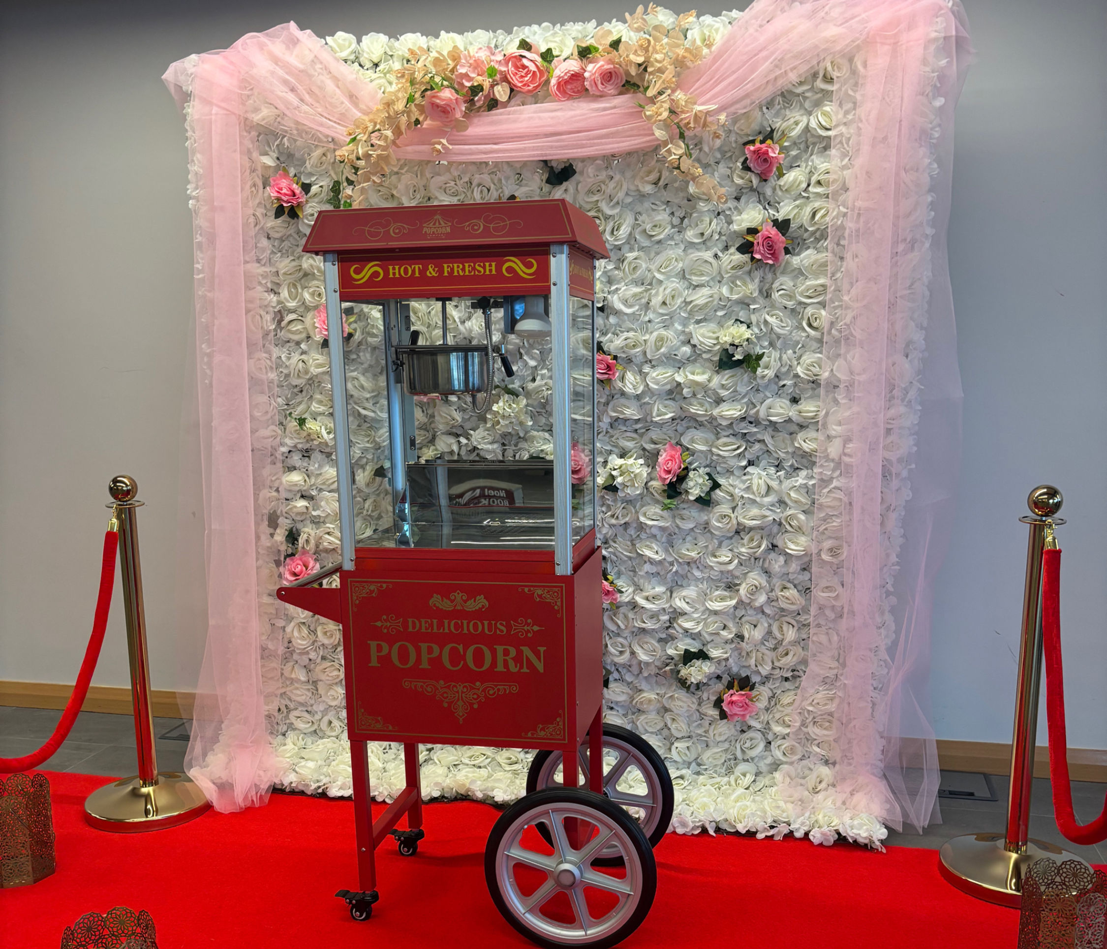 Popcorn Cart on Red Carpet with Flower Wall