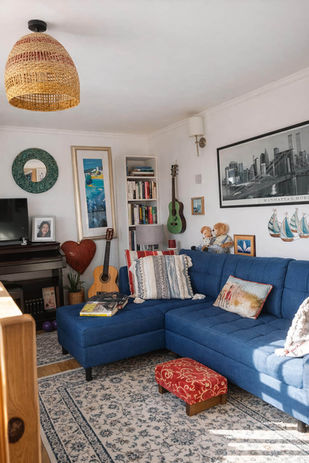 Cozy living room with blue sectional sofa and rug