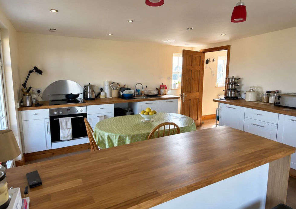 Spacious kitchen and dining area aboard Perch houseboat with wooden worktops.