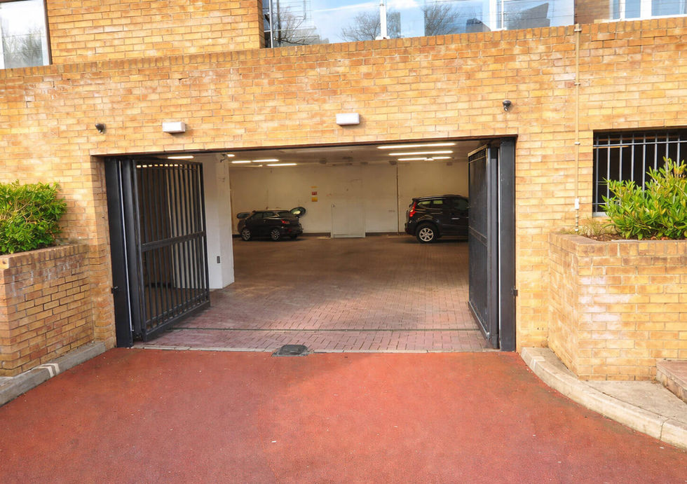 Secure underground parking entrance near riverside apartments and houseboats