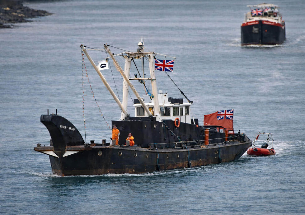 A working boat navigates the river alongside another boat.  