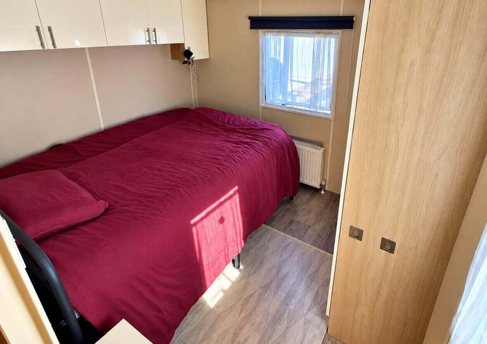 Double bedroom aboard Peggy Rose with fitted cupboards and built-in storage.