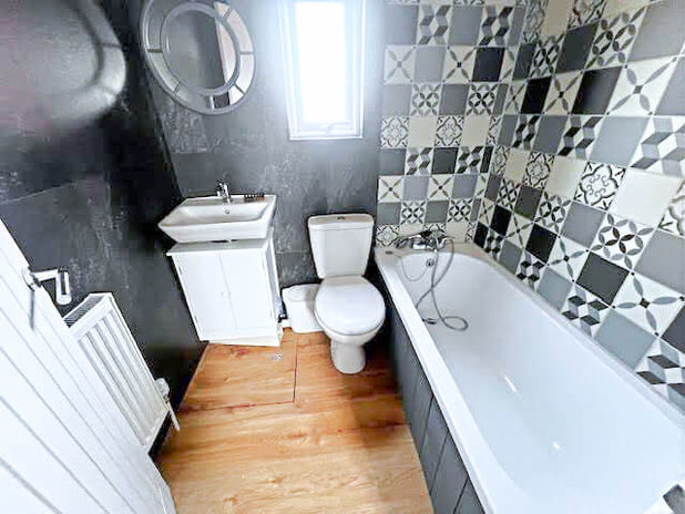 A bathroom with a bathtub and a toilet