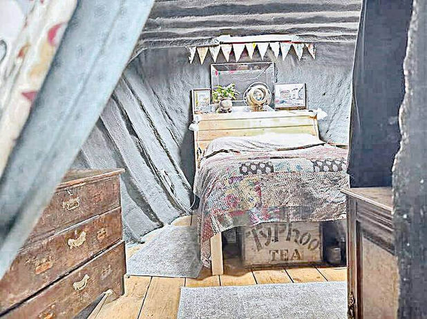 Cozy cabin interior: bed, table, tea box