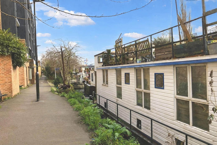 White house boat moored on a London canal path