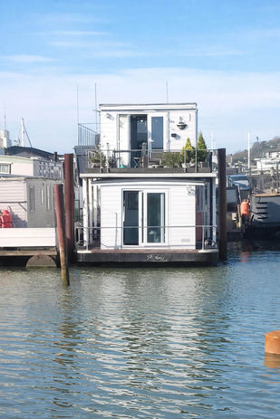 White houseboat on calm water