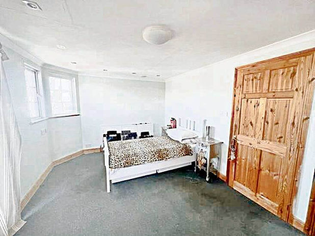 A room with a bed and a door