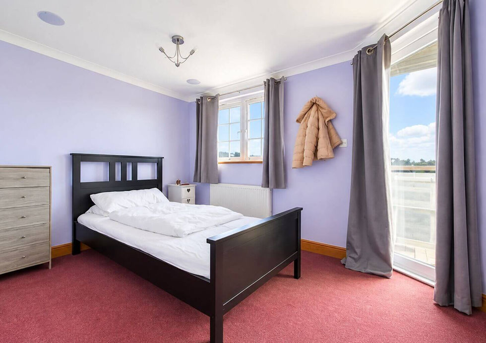 Spacious double bedroom aboard Perch houseboat with fitted storage.