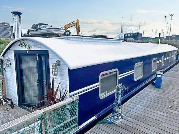 A blue and white boat on a dock