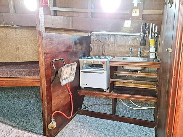 A small kitchen with a sink and a stove
