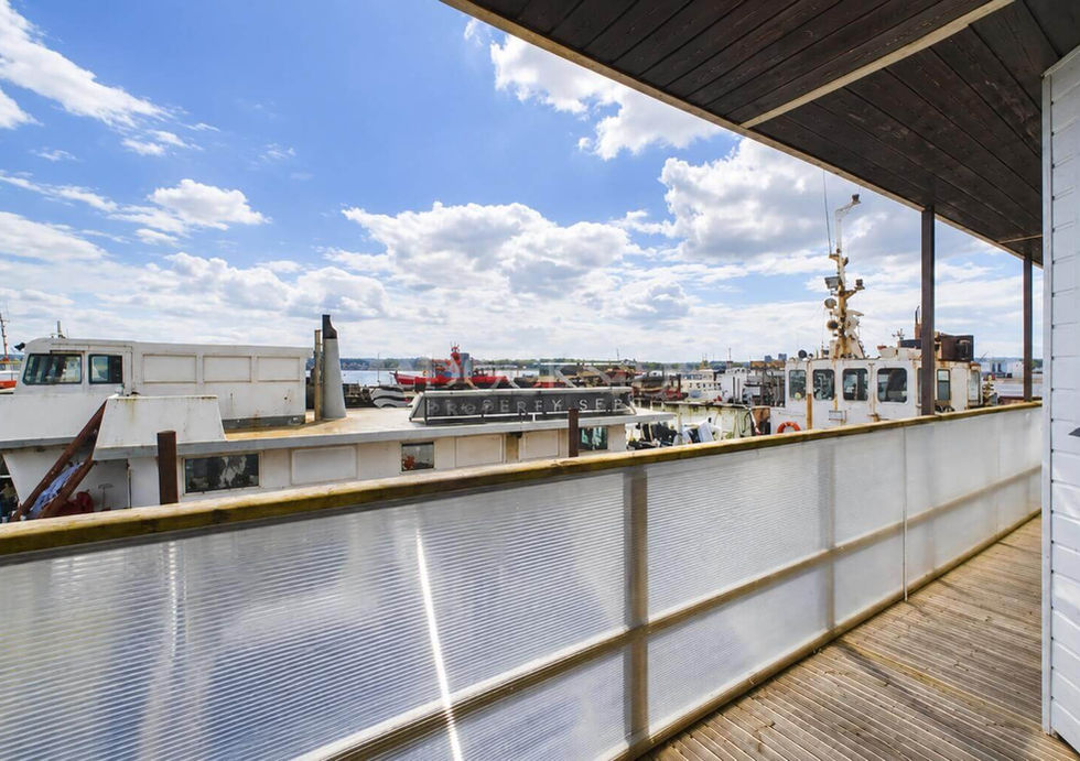 Covered exterior deck aboard Perch houseboat overlooking the marina.