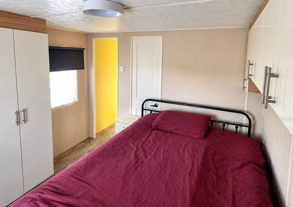 Spacious main double bedroom with extensive storage aboard Peggy Rose floating home.