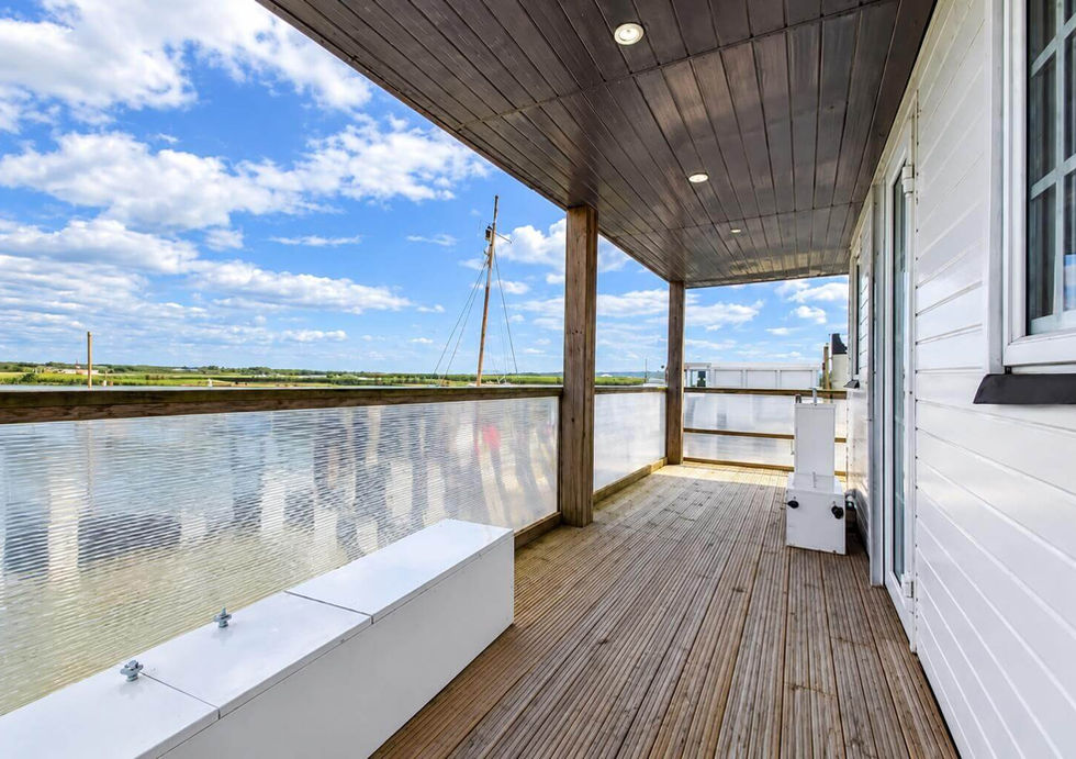 Covered deck aboard Perch houseboat with open waterside views.