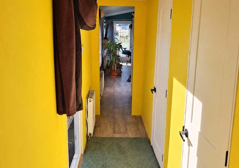 Bright hallway connecting the living area and bedrooms aboard Peggy Rose.