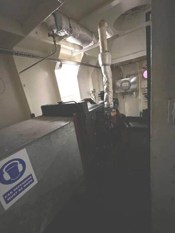 A room with a large vent and a window