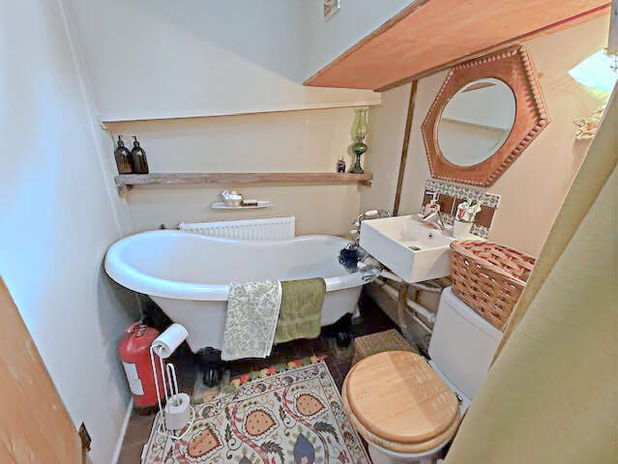 Cozy bathroom with a bathtub, toilet, and sink; visible elements