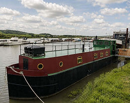 Roderick Peplow Dutch style cruising barge on secure residential mooring with large roof terrace.