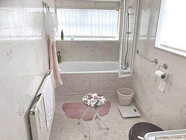 A bathroom with a stool and a bathtub