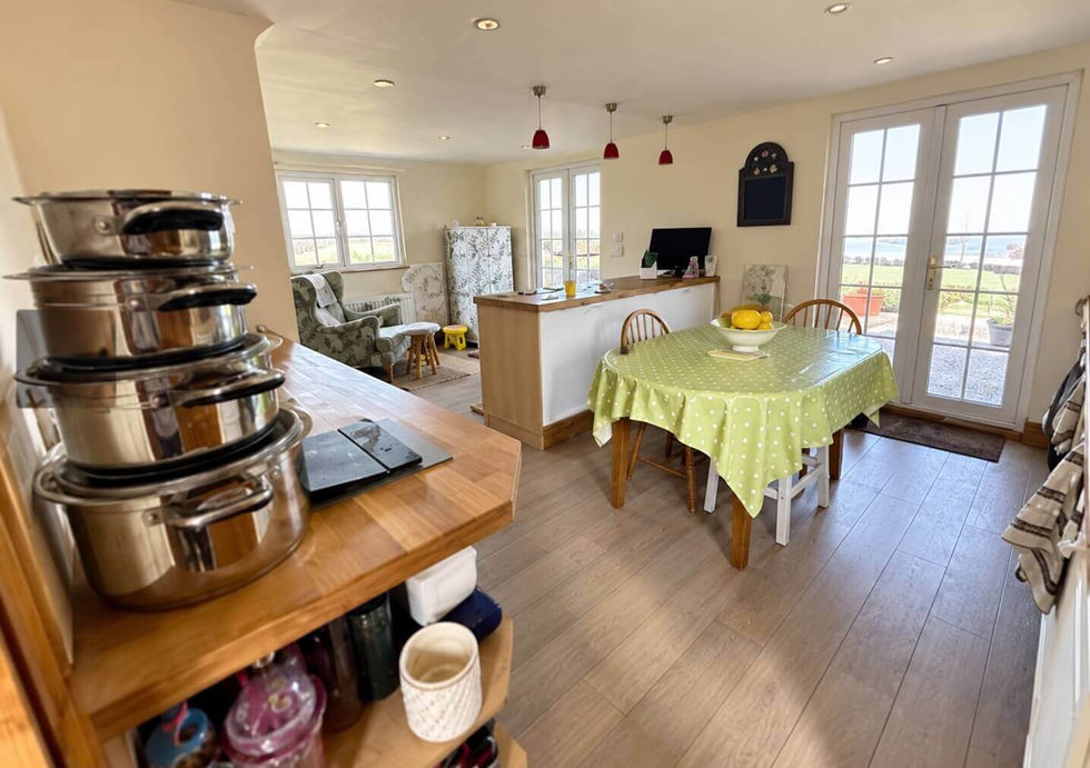 Open-plan kitchen and dining area aboard Perch houseboat with French doors.