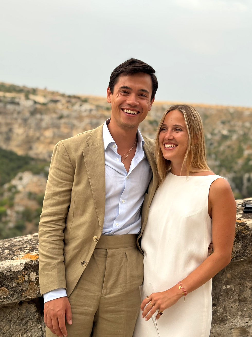 Smiling couple posing outdoors in formal attire