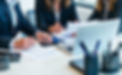 Accountants discussing tax at a desk with a laptop and stationary._edited.jpg