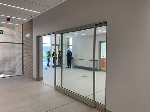 A white framed Sliding Door manufactured and installed by Aluminium Windows Cape Town