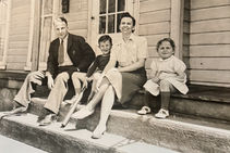 Behm family sitting on the front porch of their Madison, Ohio home