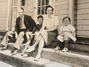 Behm family sitting on the front porch of their Madison, Ohio home